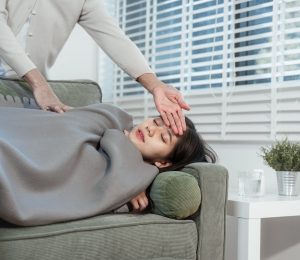 an-elderly-asian-woman-gently-checks-her-sick-daug-2025-10-06-19-06-24-utc-scaled.jpg