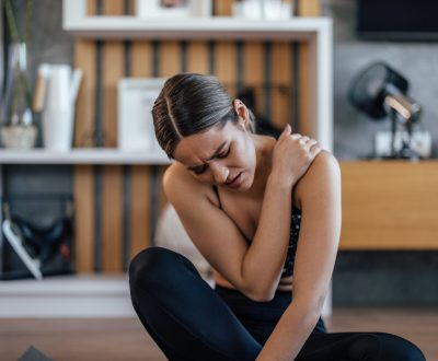 girl-having-shoulder-pain-sitting-on-a-sports-mat-2025-11-13-22-15-09-utc-scaled.jpg